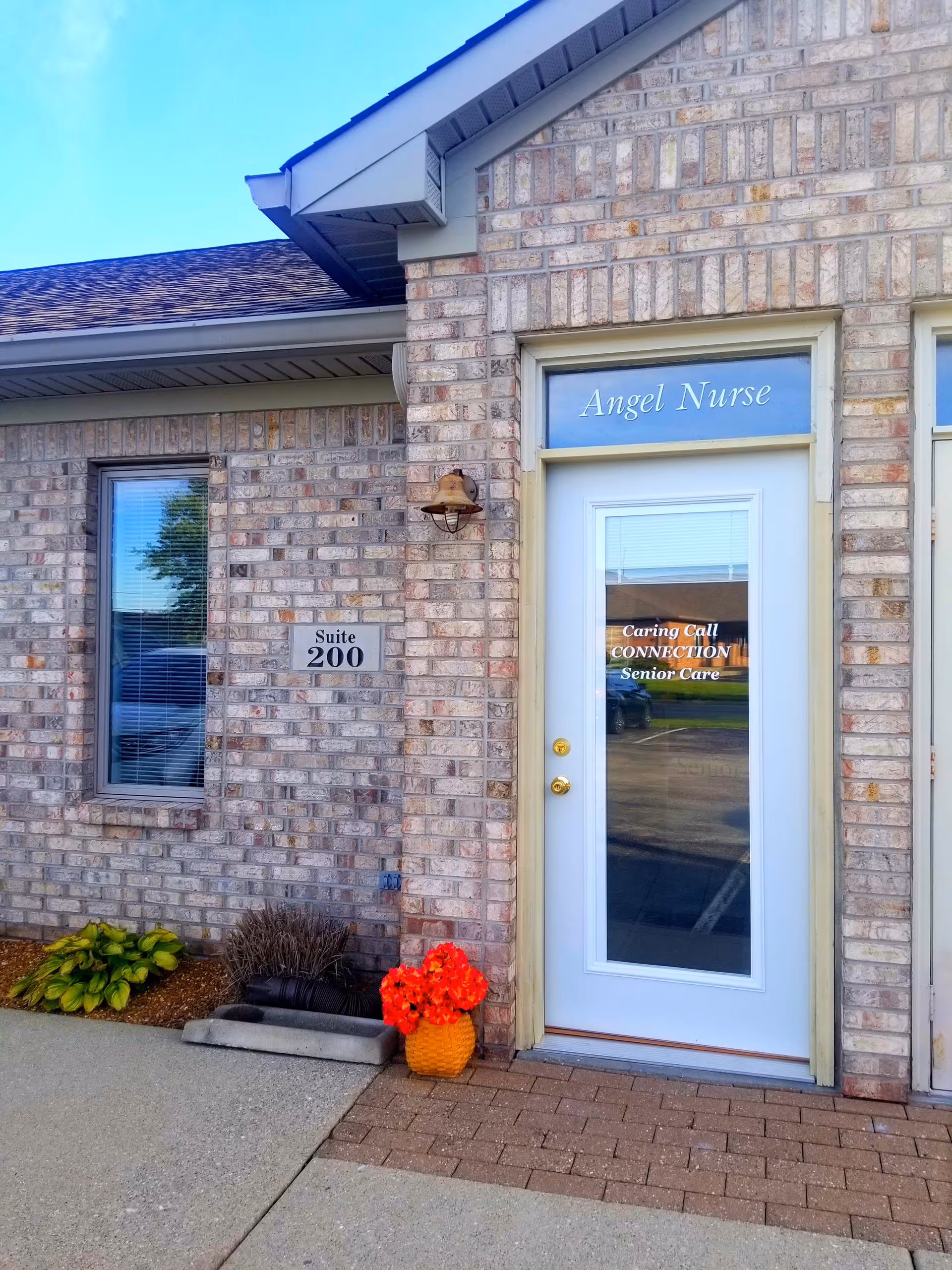 Brick exterior of a senior care facility front entrance with Angel Nurse door.