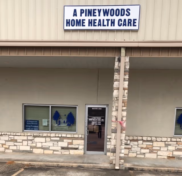 Exterior view of a building entrance with a sign reading A Pineywoods Home Health Care.