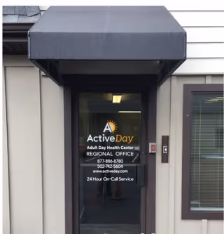 Entrance of an Active Day facility with glass door and signage.