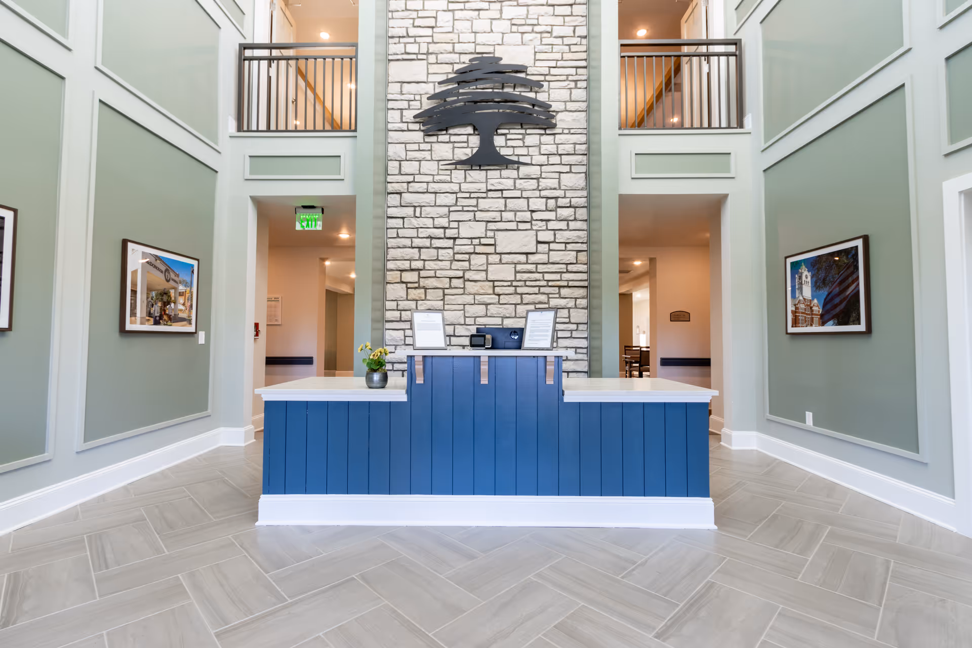 Canopy at Westridge reception area with blue front desk against a stone wall.