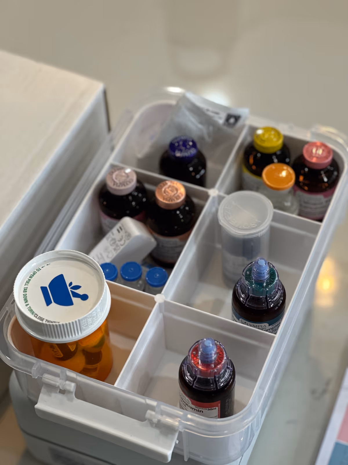 Open medication organizer with assorted bottles in a tiered medical cart