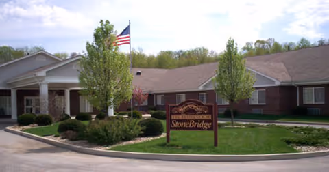 Front view of StoneBridge Health Campus with entrance, landscaping, and a sign.