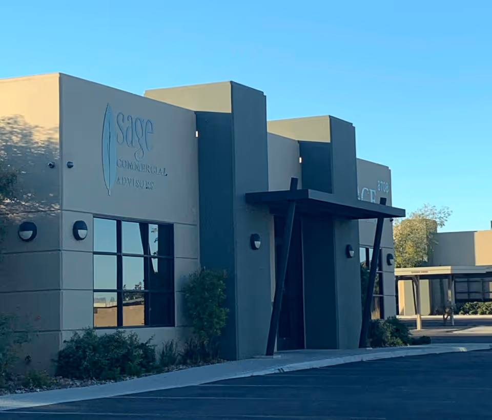 Modern commercial building exterior with glass windows and a prominent entry.