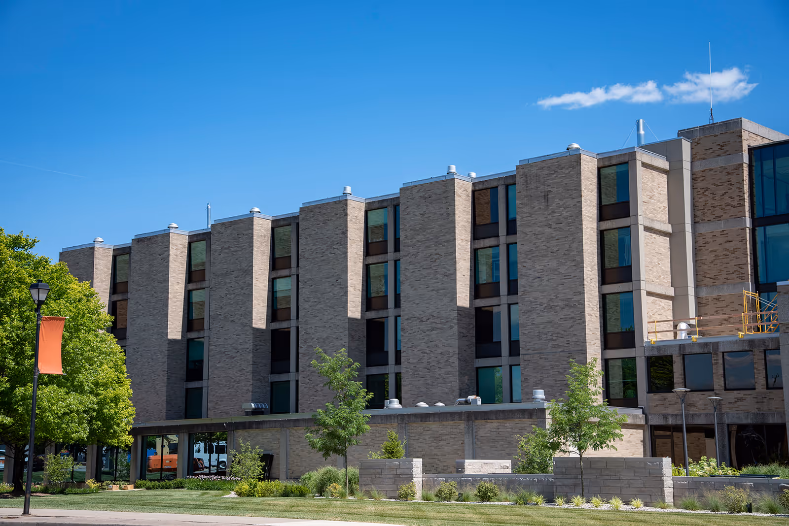Exterior of Schneck Medical Center Home Health, a multi-story brick building with glass windows and landscaping.