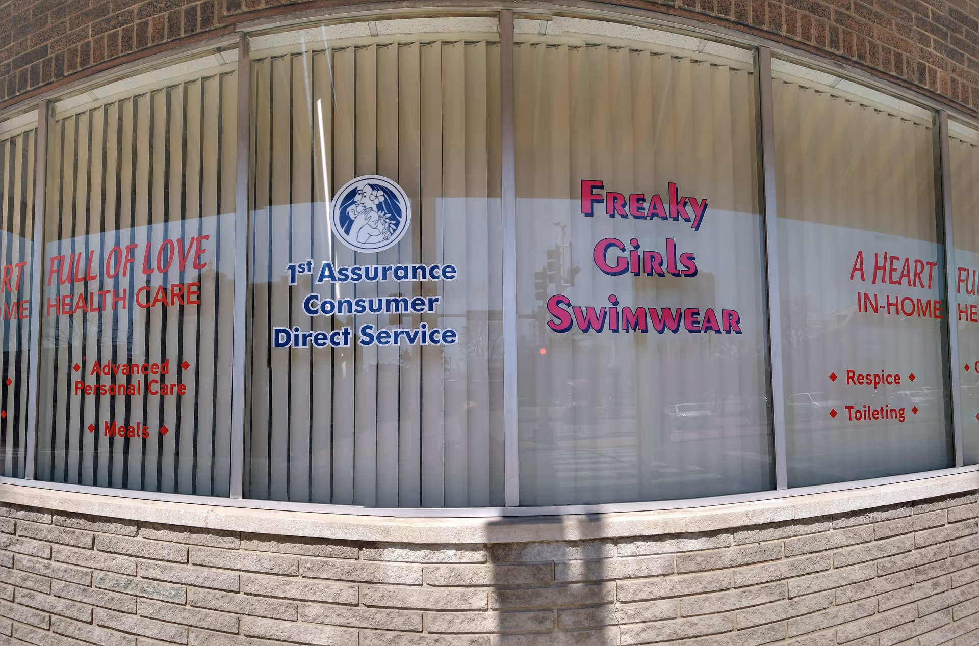 Storefront windows display A Heart Full of Love and Freaky Girls Swimwear signs.