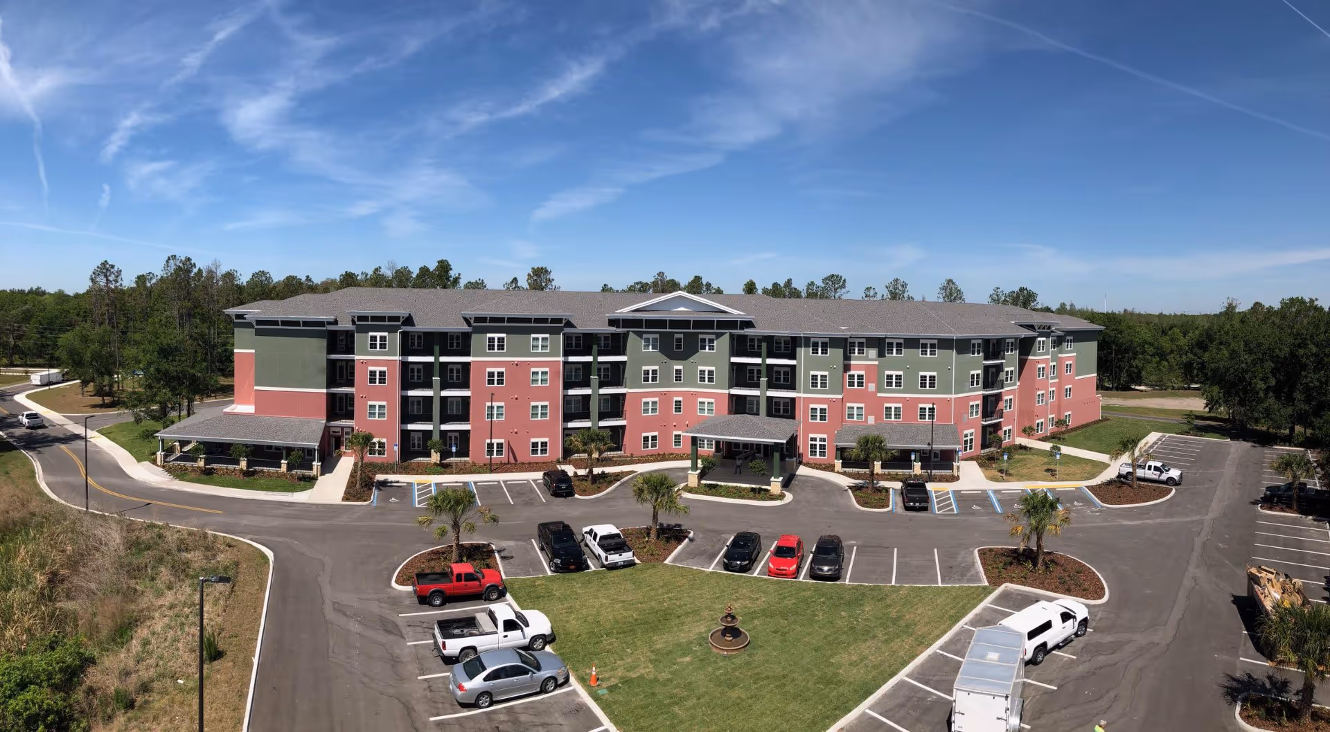 Exterior view of Keystone Place at Terra Bella, a multi-story senior living building with parking