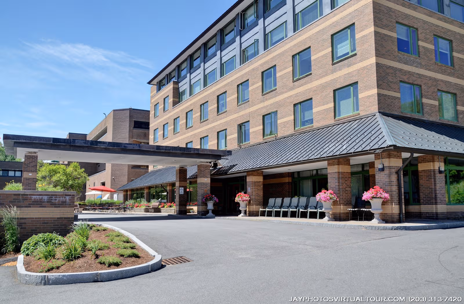 Exterior view of Eisenberg Assisted Living Residence with a covered entrance and seating.