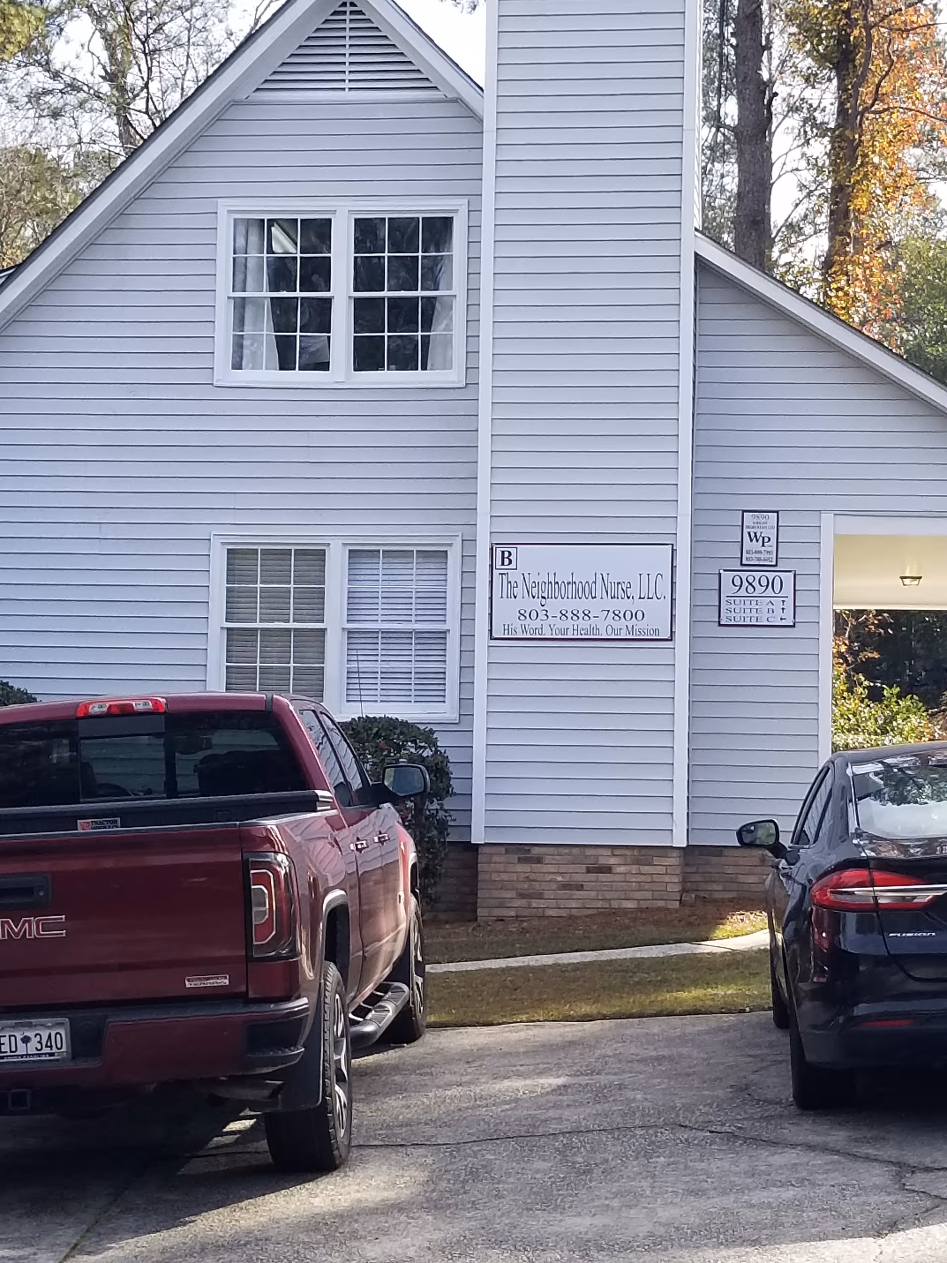 Exterior view of a light-gray building with a sign reading The Neighborhood Nurse, LLC.