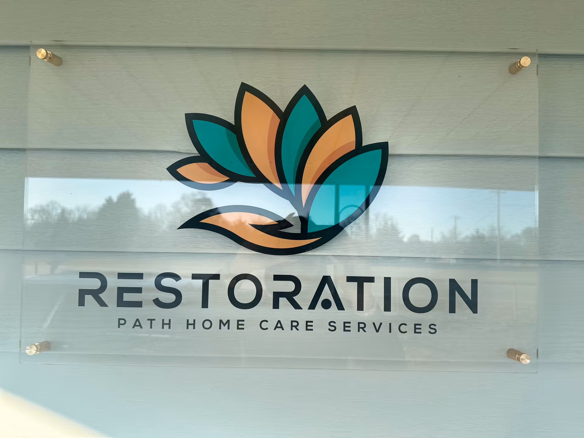 Signboard with Restoration Path Home Care Services logo on an exterior wall.