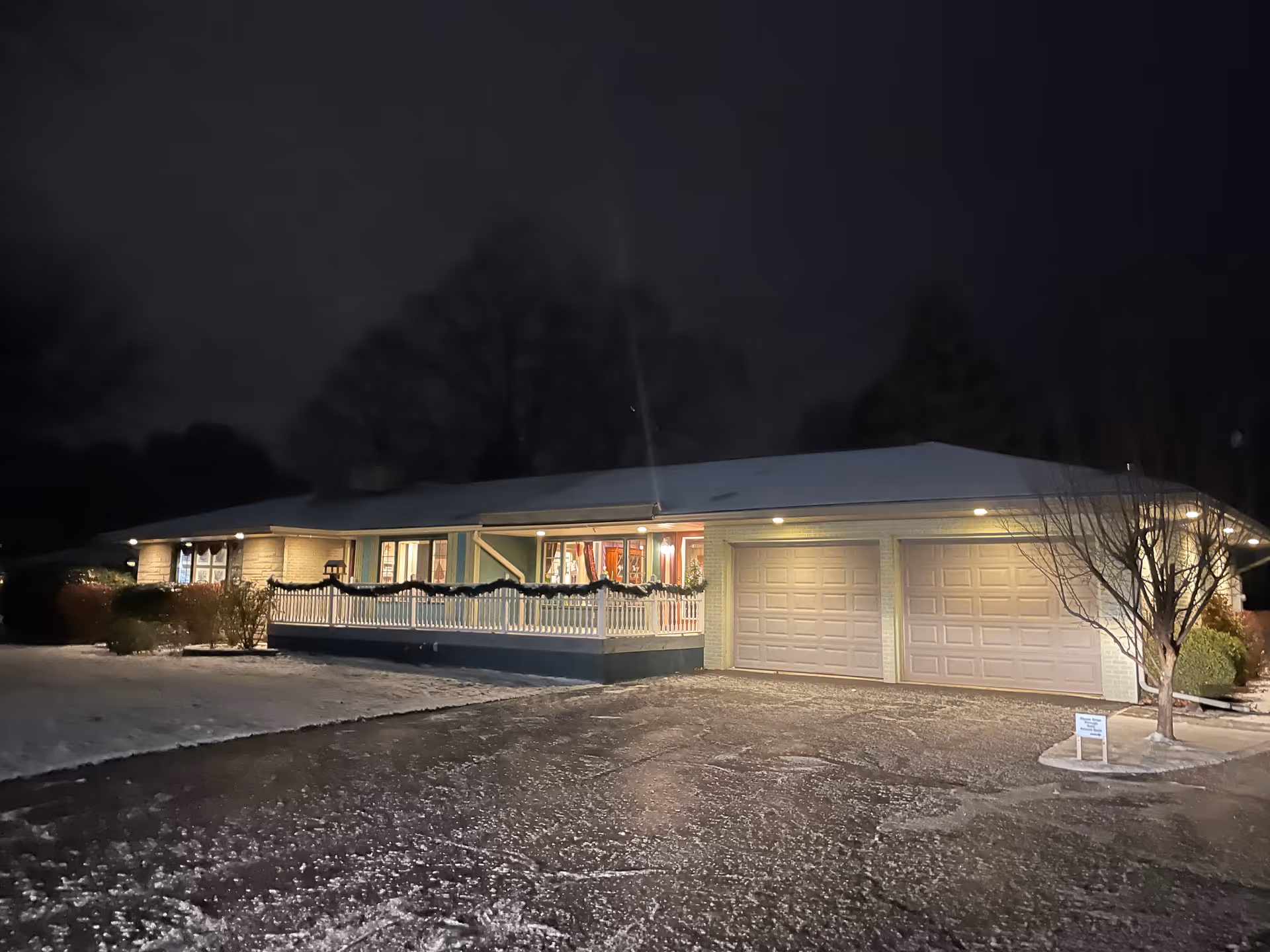 Night exterior of Rosewood AFC of DeWitt, a single-story building with a lit front porch.