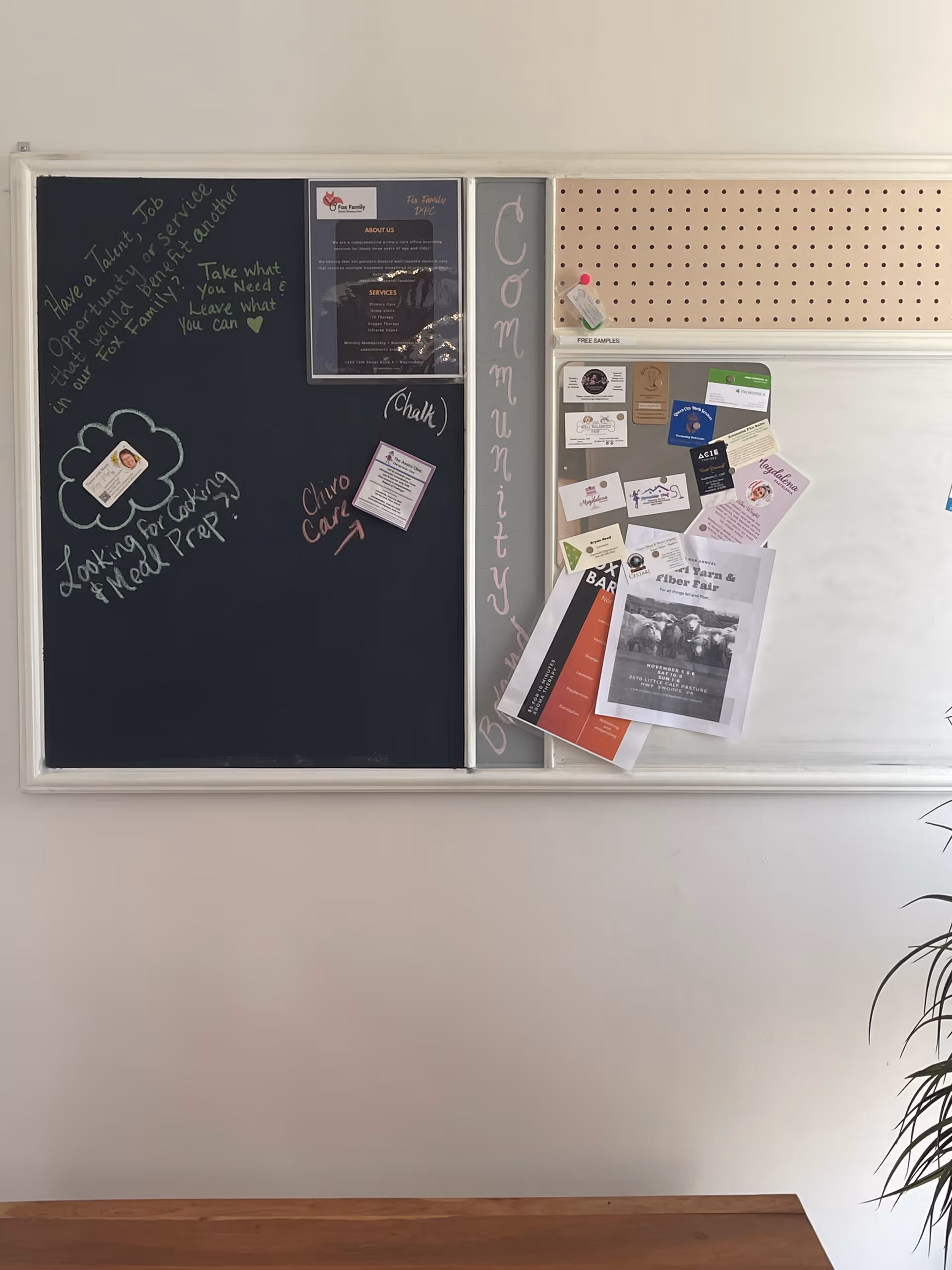 Chalkboard with notes and a corkboard display mounted on a wall in a common area.