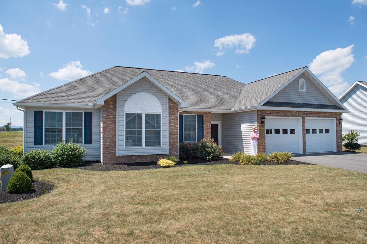 Front exterior of Buffalo Valley Lutheran Village, a single-story senior living facility with a two-car garage.
