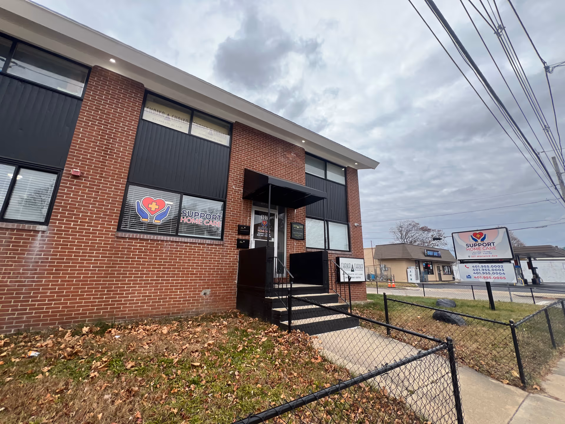 Brick building exterior with front entrance and Support Home Care signage