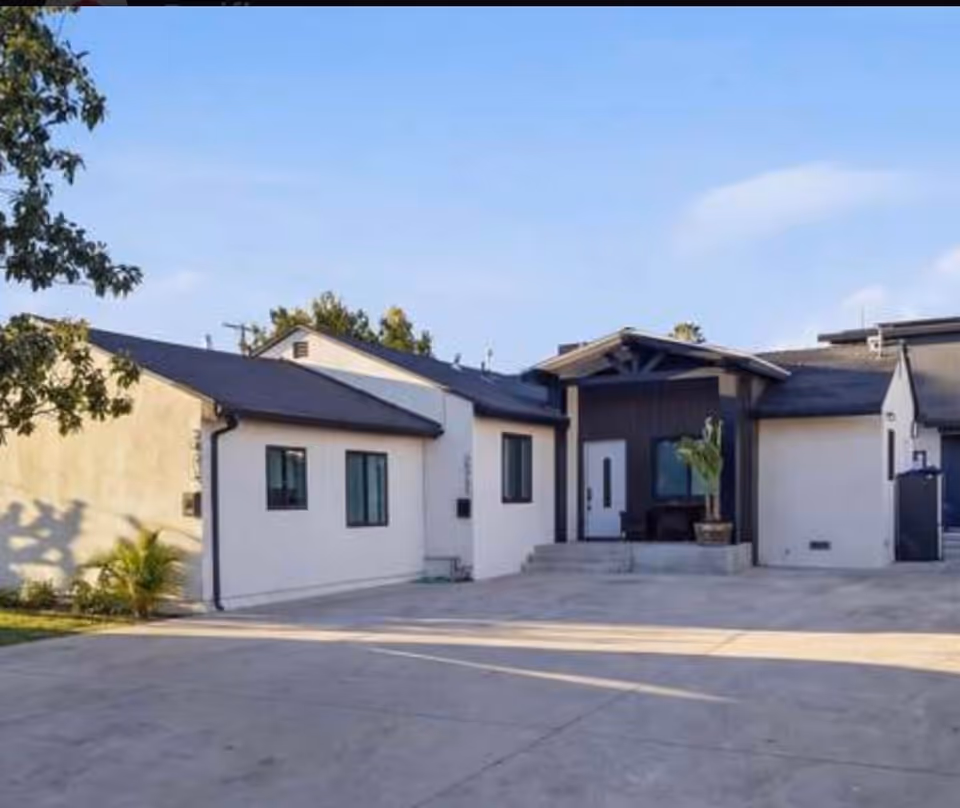 Exterior view of a modern senior living facility with driveway and entrance.