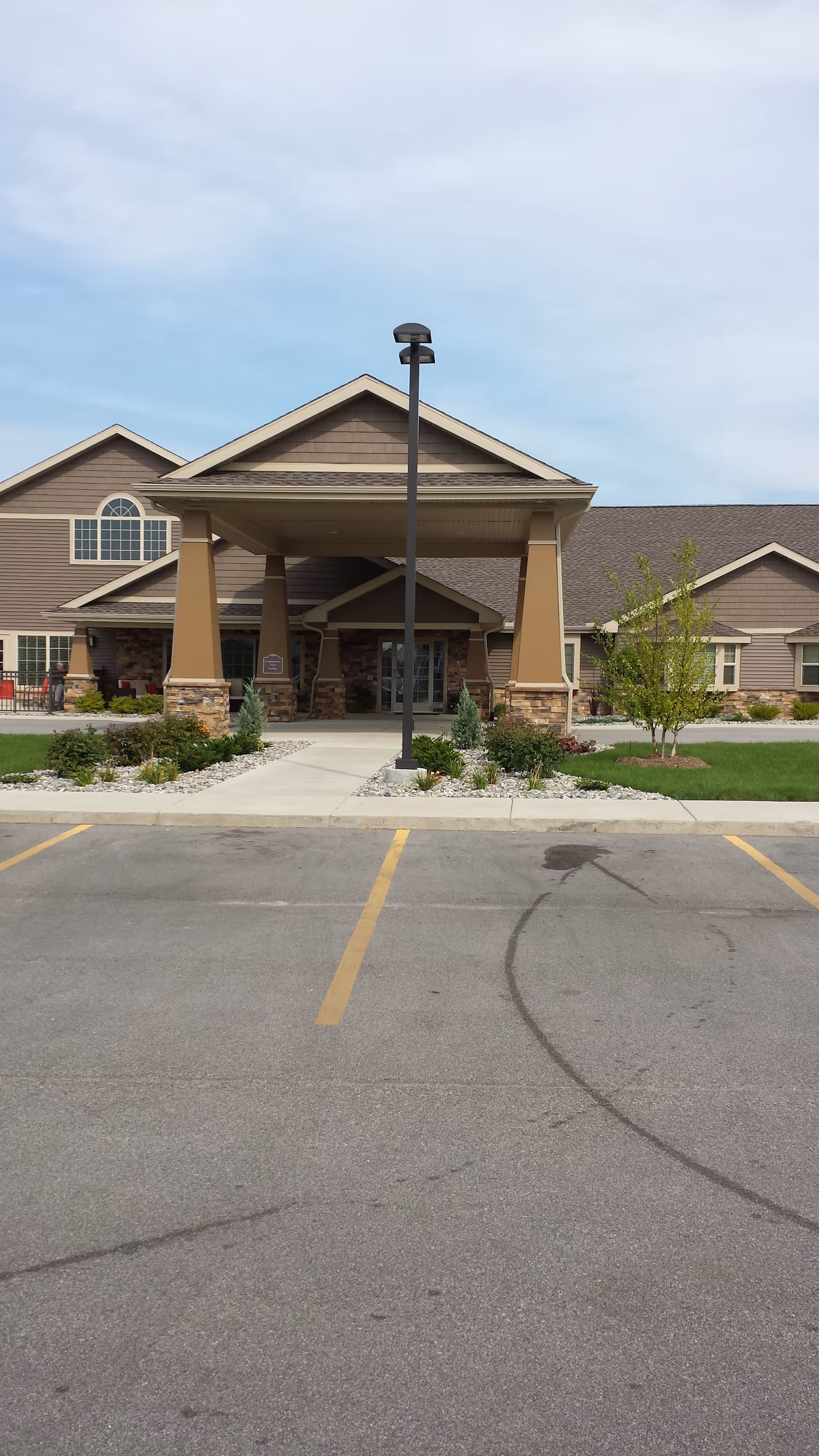 Front view of Charter Senior Living of Bay City entrance with porte-cochere.