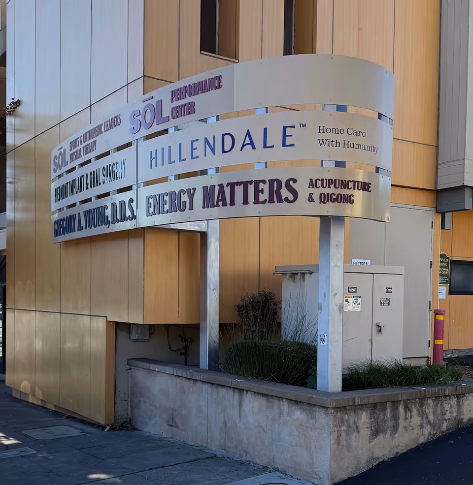 Exterior view of a building with a curved sign noting Hillendale Home Care and other services.
