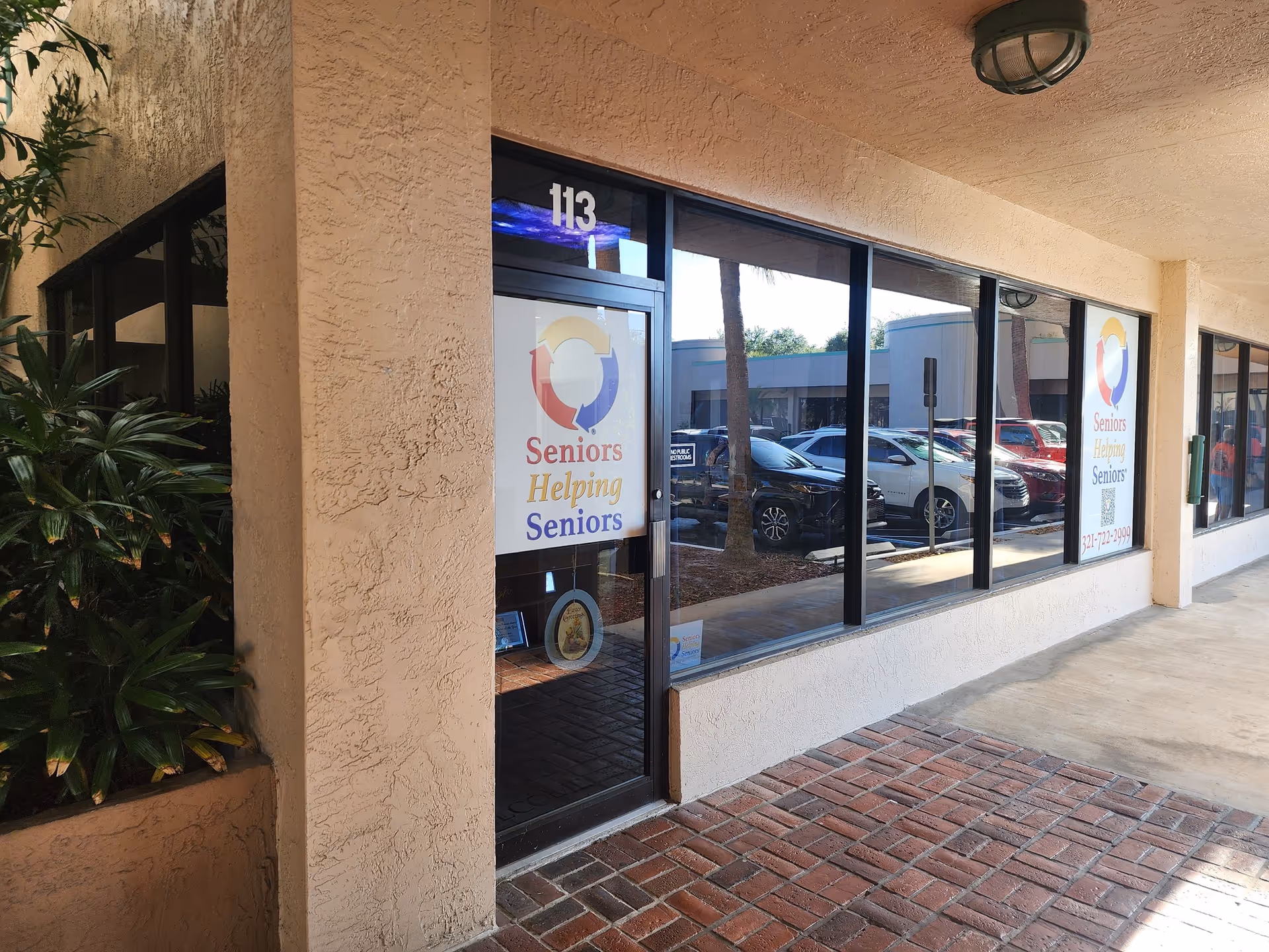 Exterior storefront of a seniors facility with banners on glass windows.