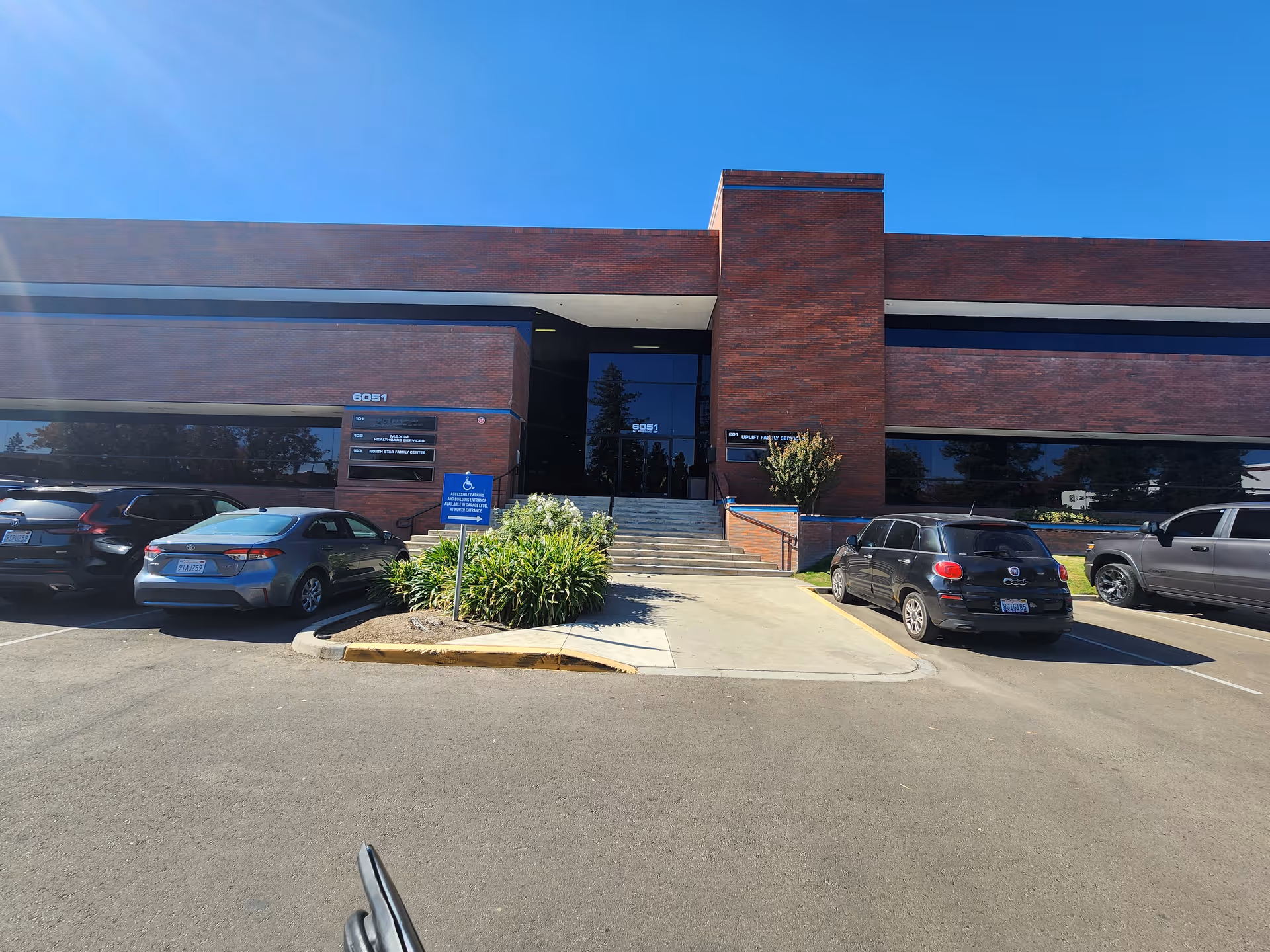 Brick office building with parking lot and accessible entrance.