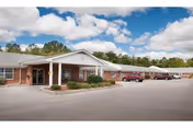 Front view of Albany Health and Rehabilitation Center with brick facade, entrance canopy, and parked cars.