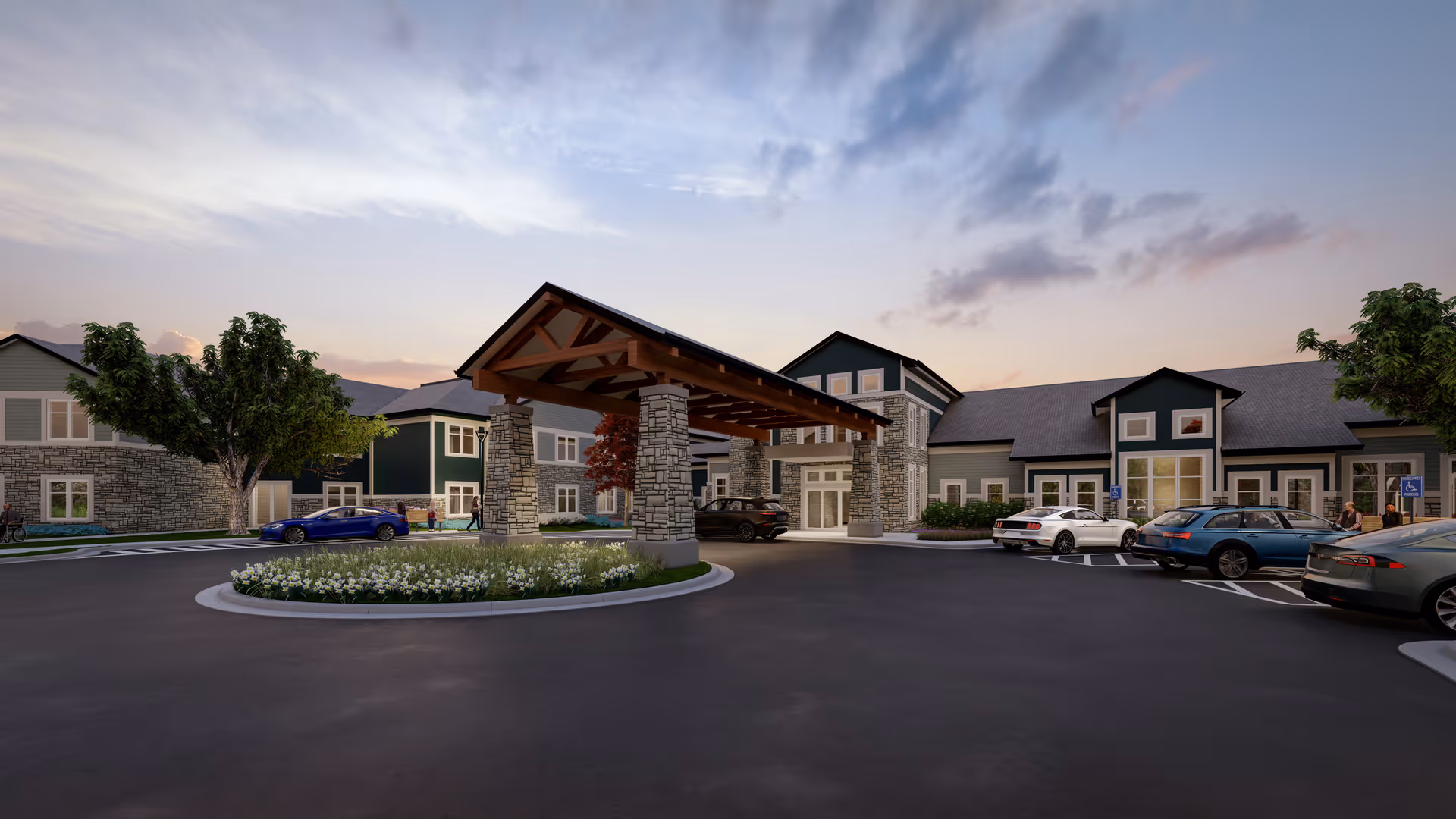 Front entrance of a senior living building with a covered porte-cochere, parked cars, and landscaped roundabout at dusk.