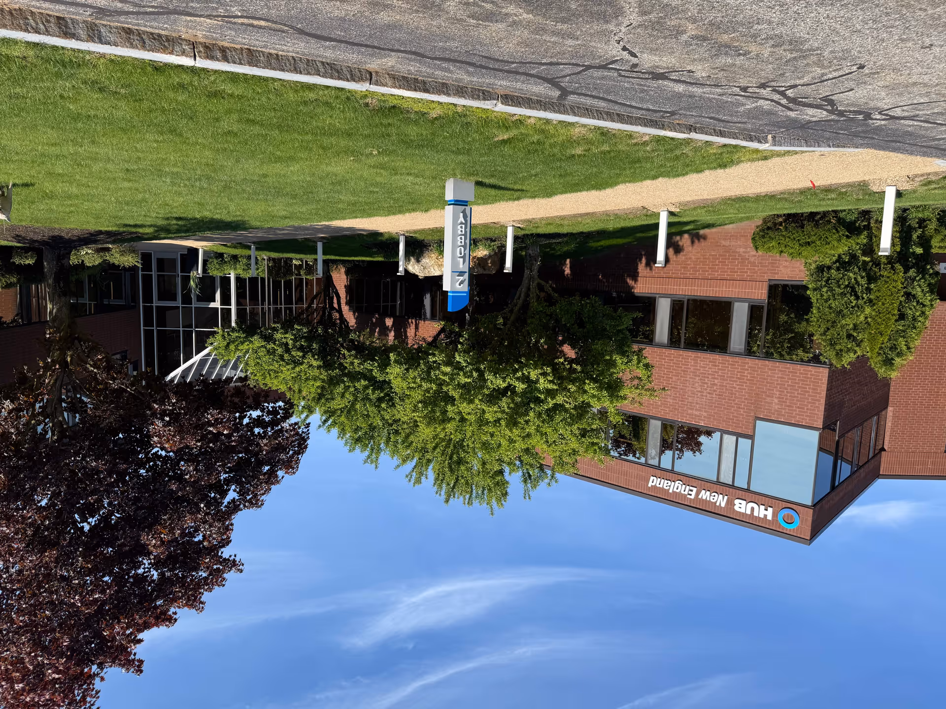 Exterior view of a BAYADA Home Health building with brick facade and surrounding trees.