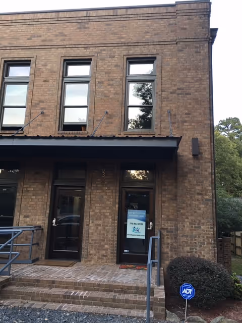 Brick building entrance to a senior living facility with glass doors
