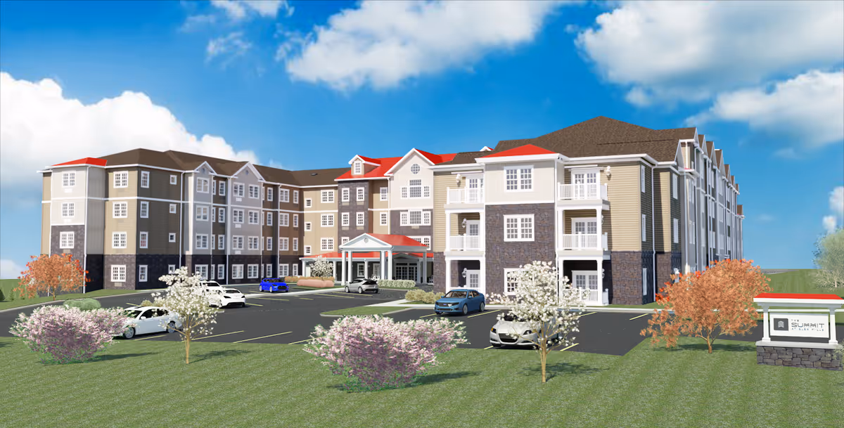 Exterior view of Merrill Gardens at Glen Mills, senior living building with parking and landscaping.