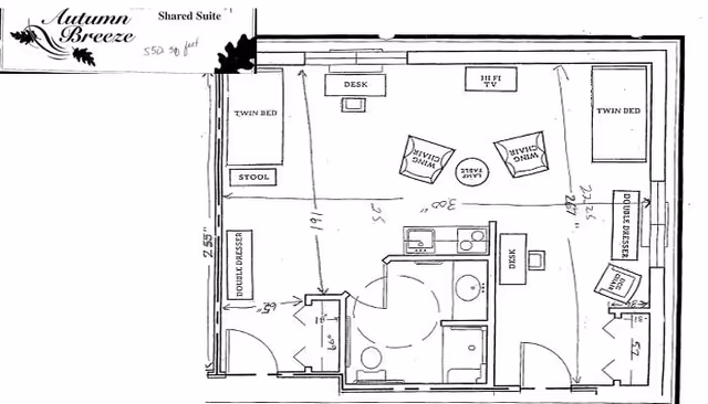 Floor plan of a shared senior living suite with two beds, desks, and a bathroom.