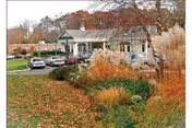 Exterior view of Hamden Rehabilitation & Health Care Center with parked cars and landscaping.