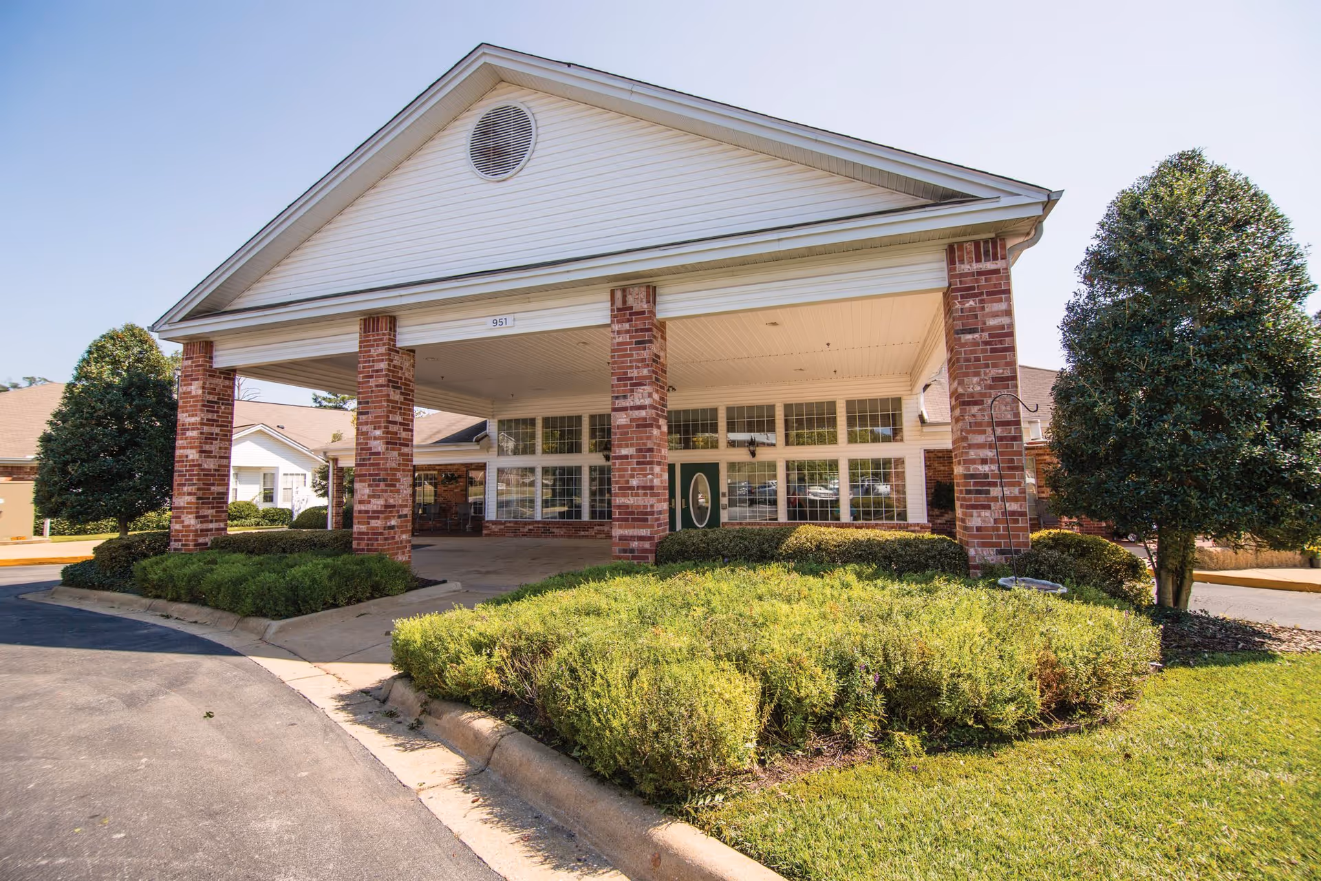 Front view of The Landings of Northport entrance with brick columns and landscaping.