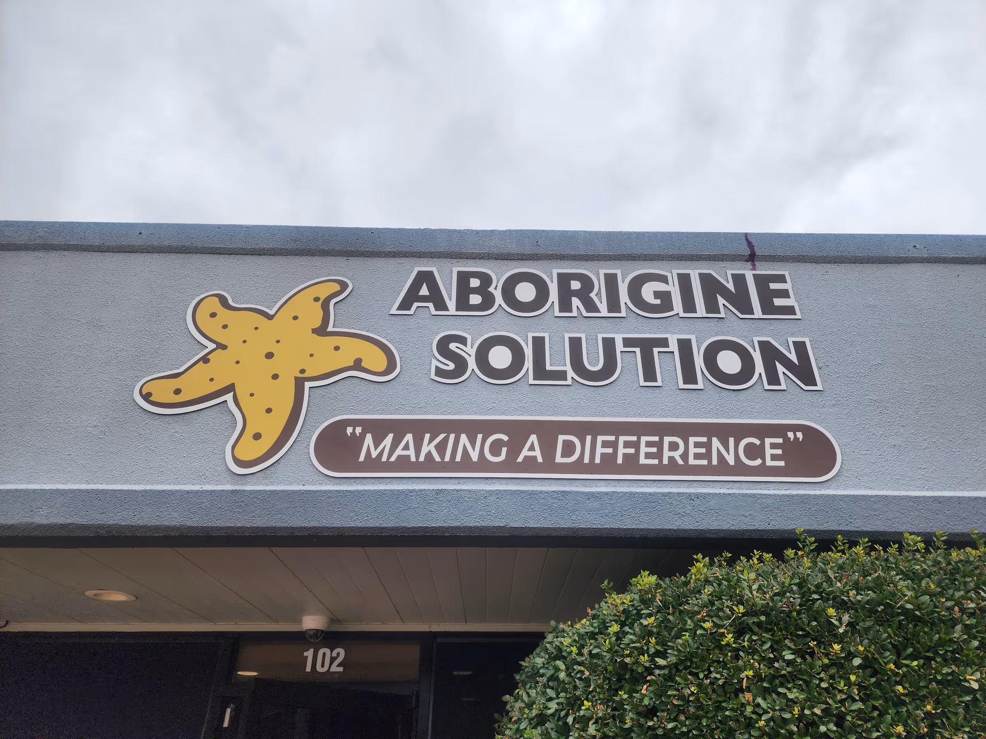 Exterior storefront of Aborigine Solution with starfish logo and 'Making a Difference' slogan.