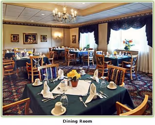 A formal dining room with multiple tables set for meals and chairs.
