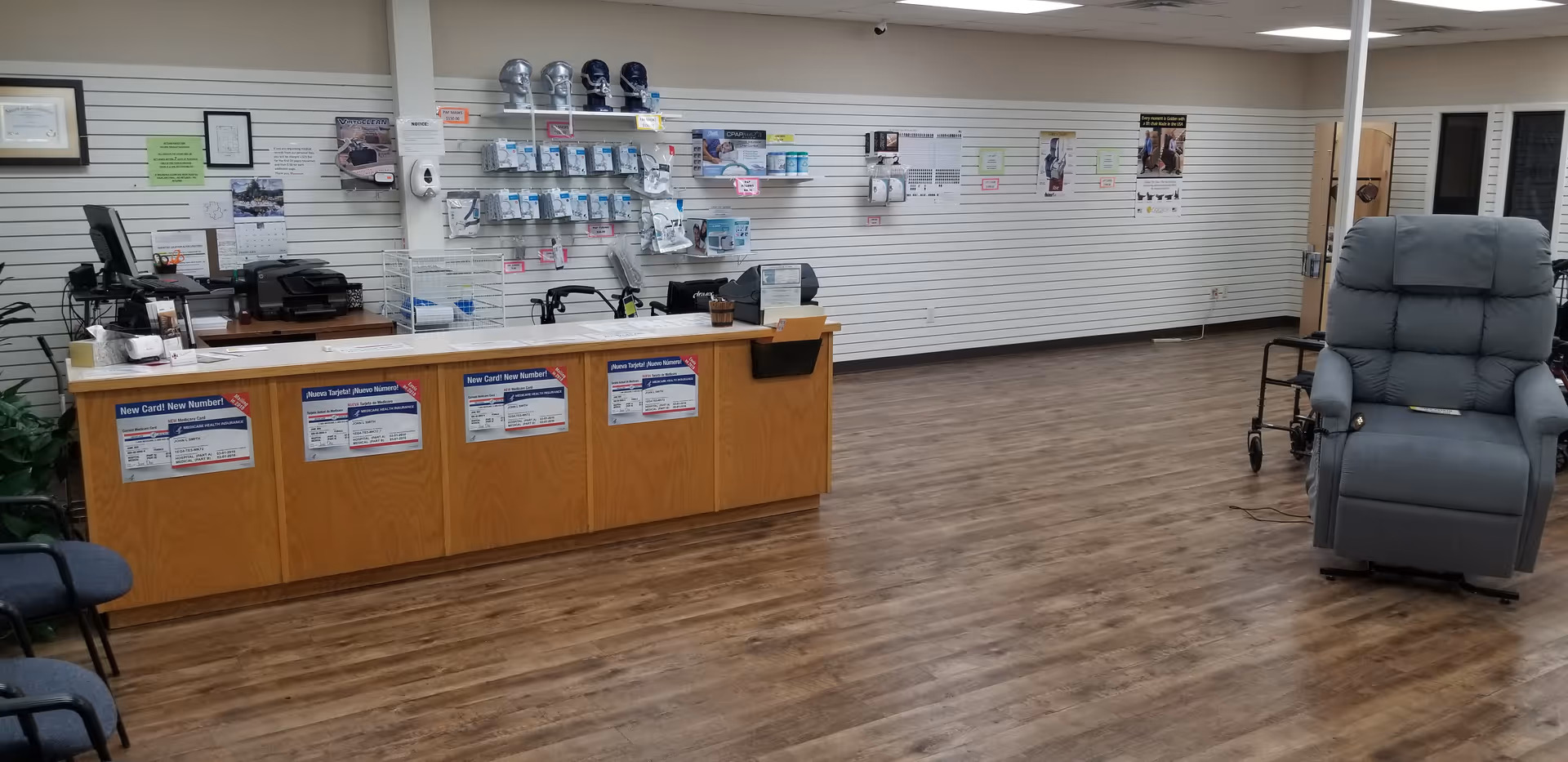 Reception desk with medical supplies on wall shelves in a senior care facility lobby.