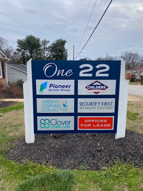 Exterior sign for Clover Care Home Care Greenville displaying multiple tenant logos.