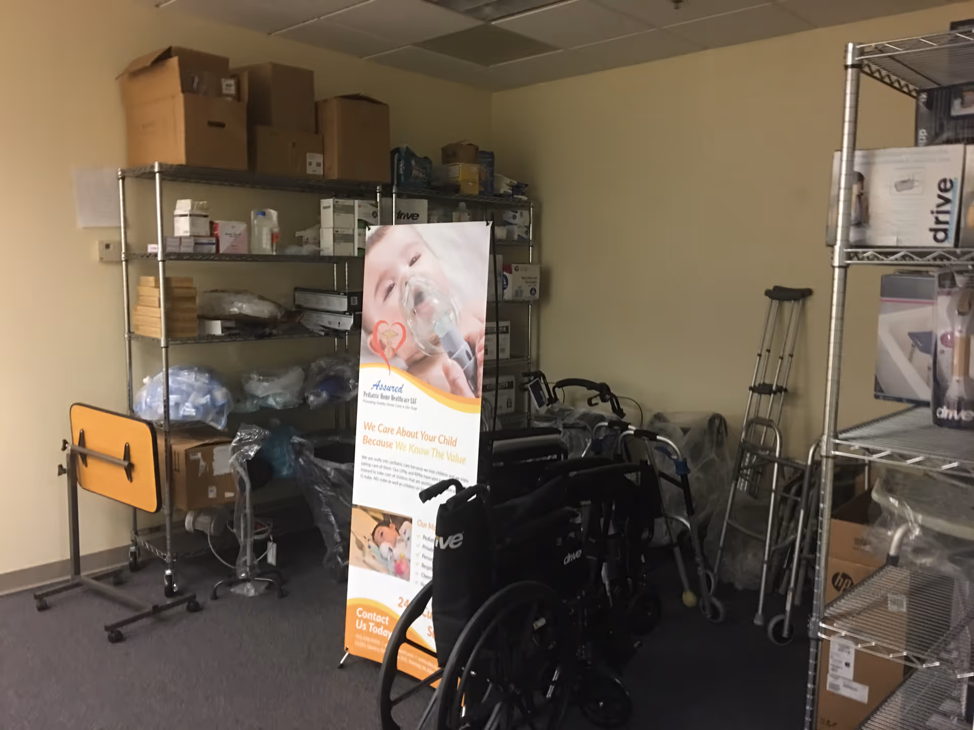 Storage room with metal shelves, medical supplies, and mobility devices in a care facility.