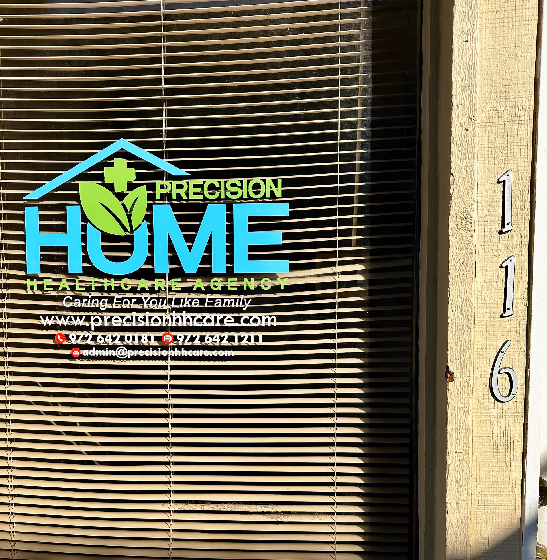 Front window with blinds and Precision Home Healthcare logo and contact info.