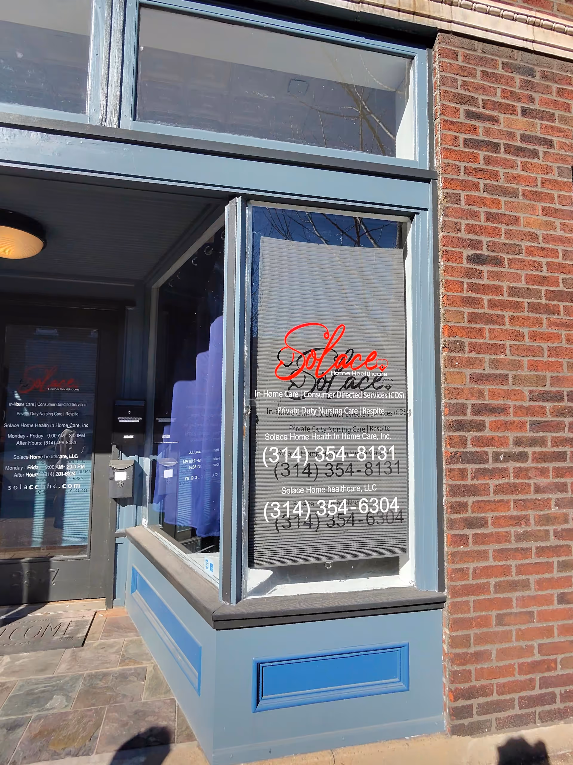 Brick building front with blue-trimmed entrance and window signage for Solace Home Healthcare.