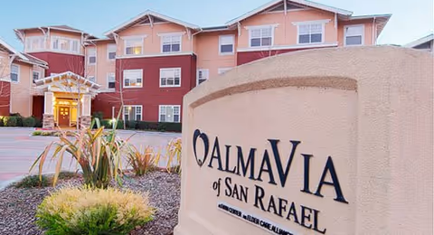 Exterior view of AlmaVia of San Rafael with a large stone sign and entrance.