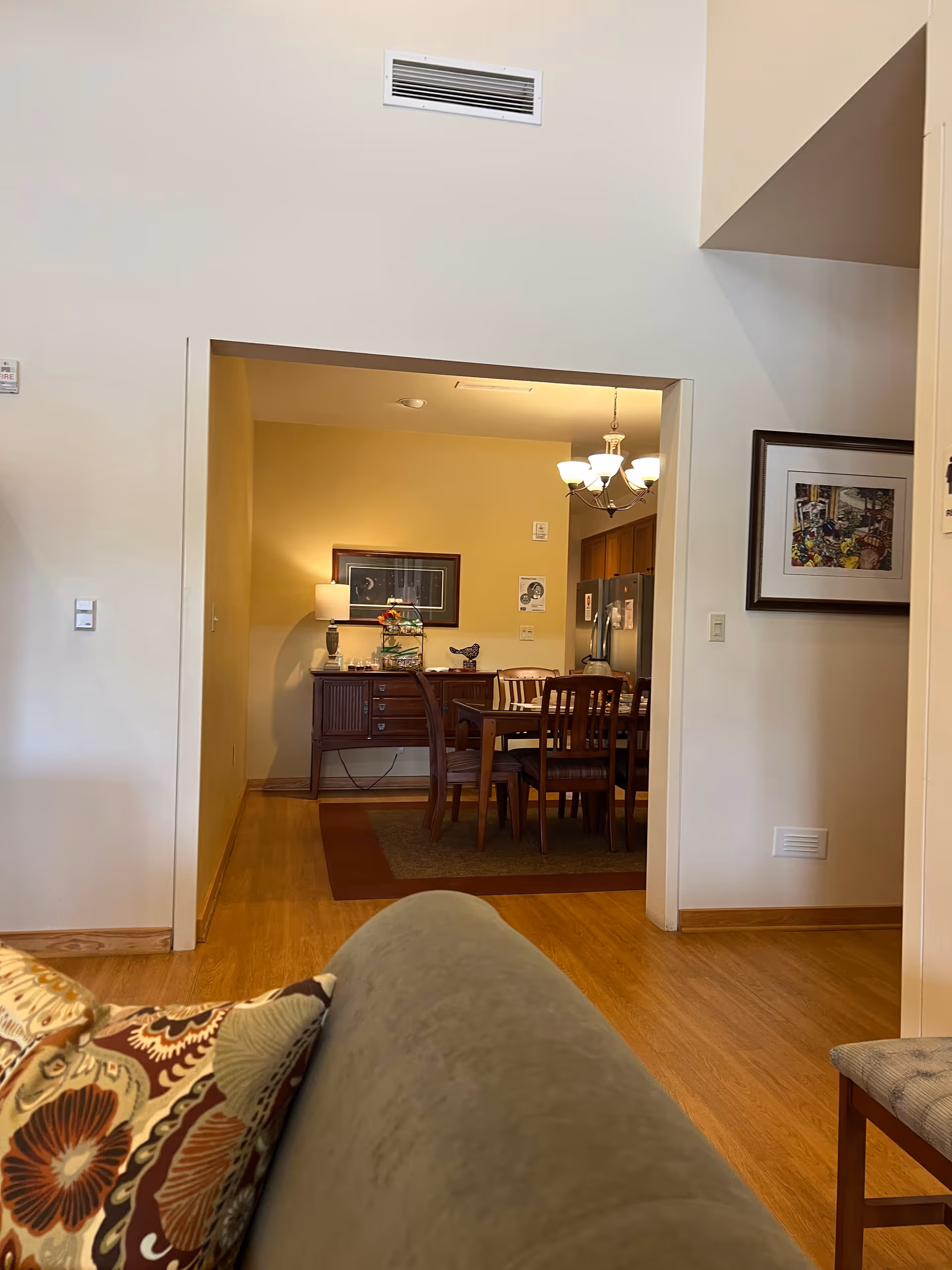 View from a living room into a dining area with a wooden table and chairs.