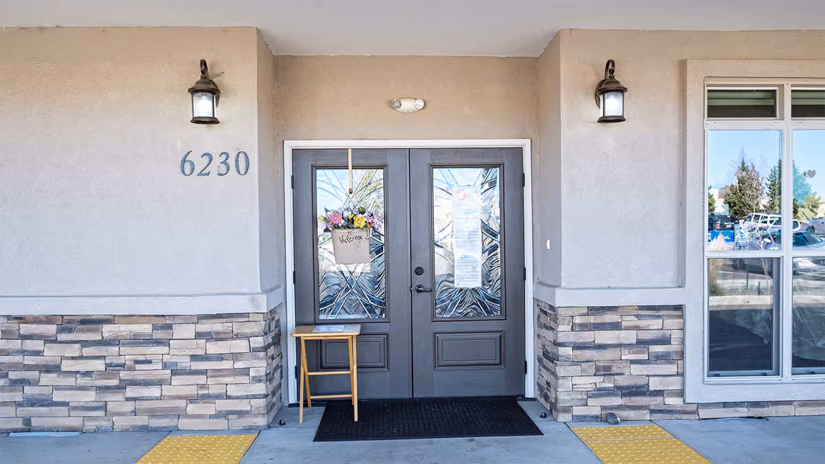 Front entrance of Bee Hive Homes of Volcano Cliffs with double doors and stone facade.