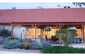 Front view of San Luis Care Center exterior with a red roof and covered porch.