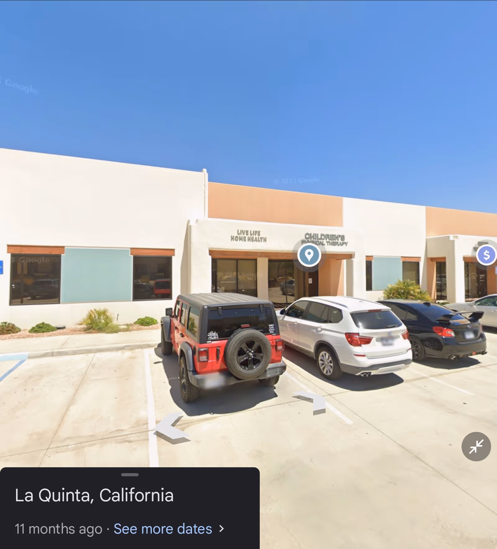 Exterior view of a single-story senior care facility with parked cars in front.