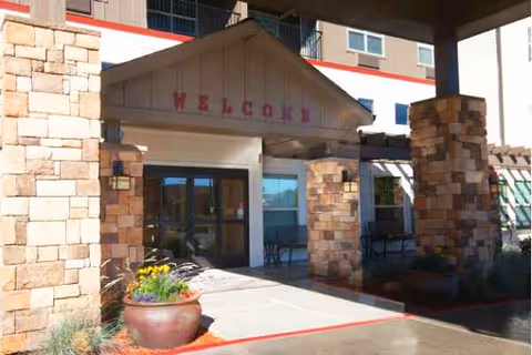 Exterior entrance of MorningStar Senior Living of Sparks with stone columns and a welcome sign.