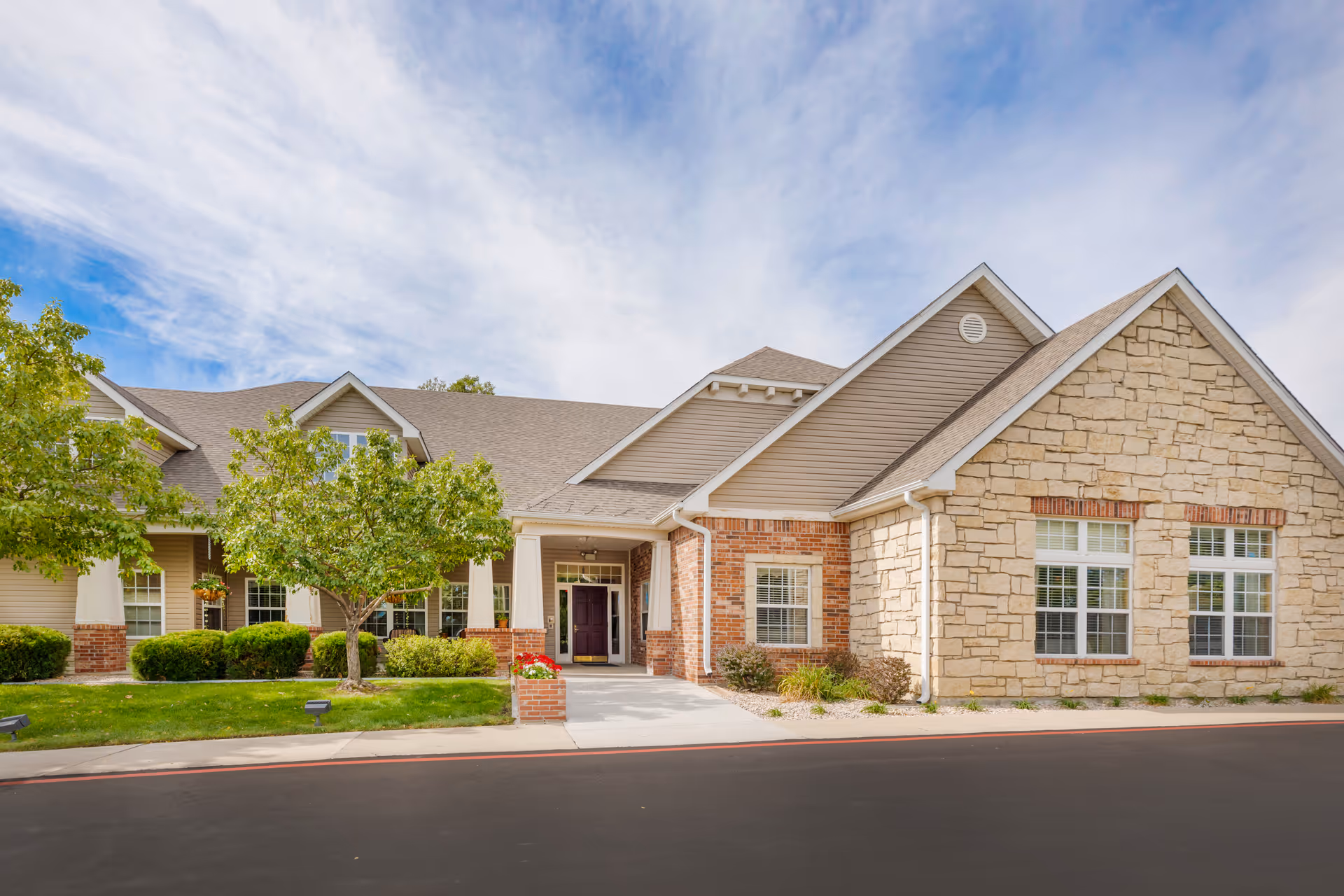 Wide view of Brookdale North Loveland front entrance with stone facade and landscaping
