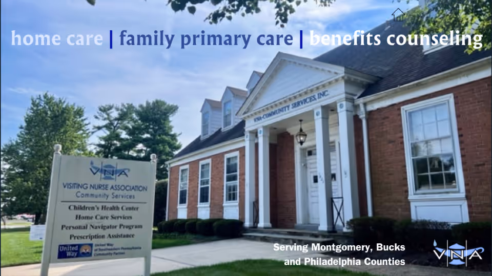 Brick building with white columns and a signboard outside Visiting Nurse Association Community Services.