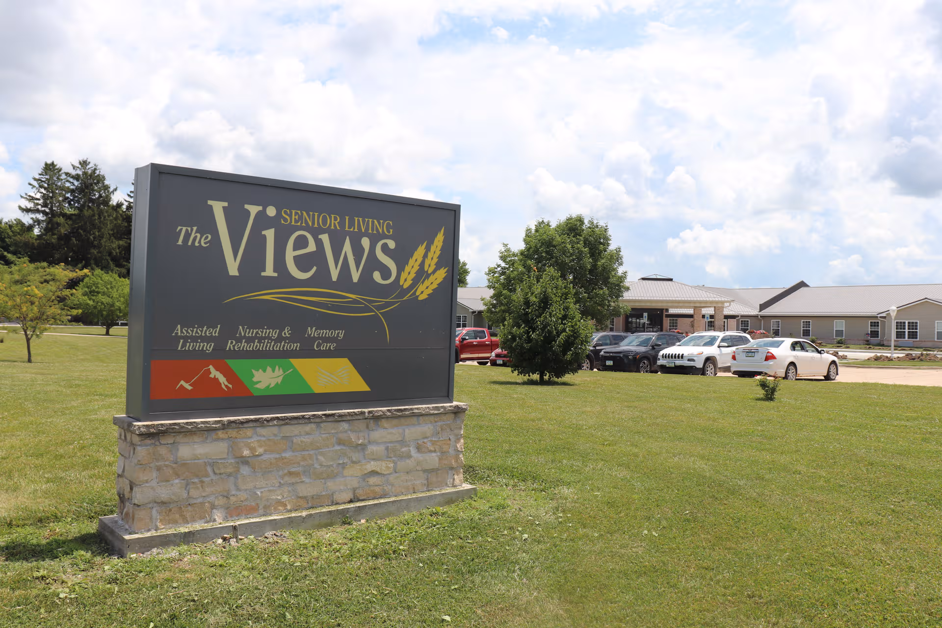 Outdoor scene with The Views sign and a parking lot in front of a low-rise building.