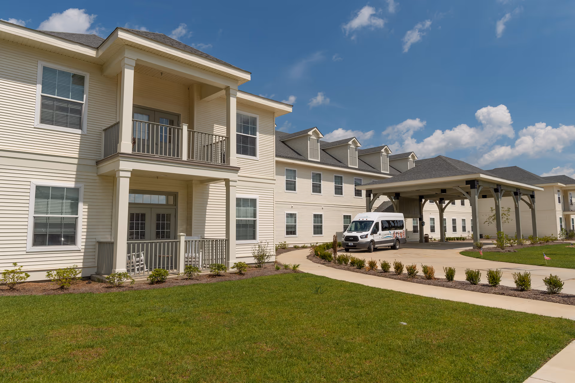 Exterior of Francois Bend Senior Living building with covered entrance and landscaping.
