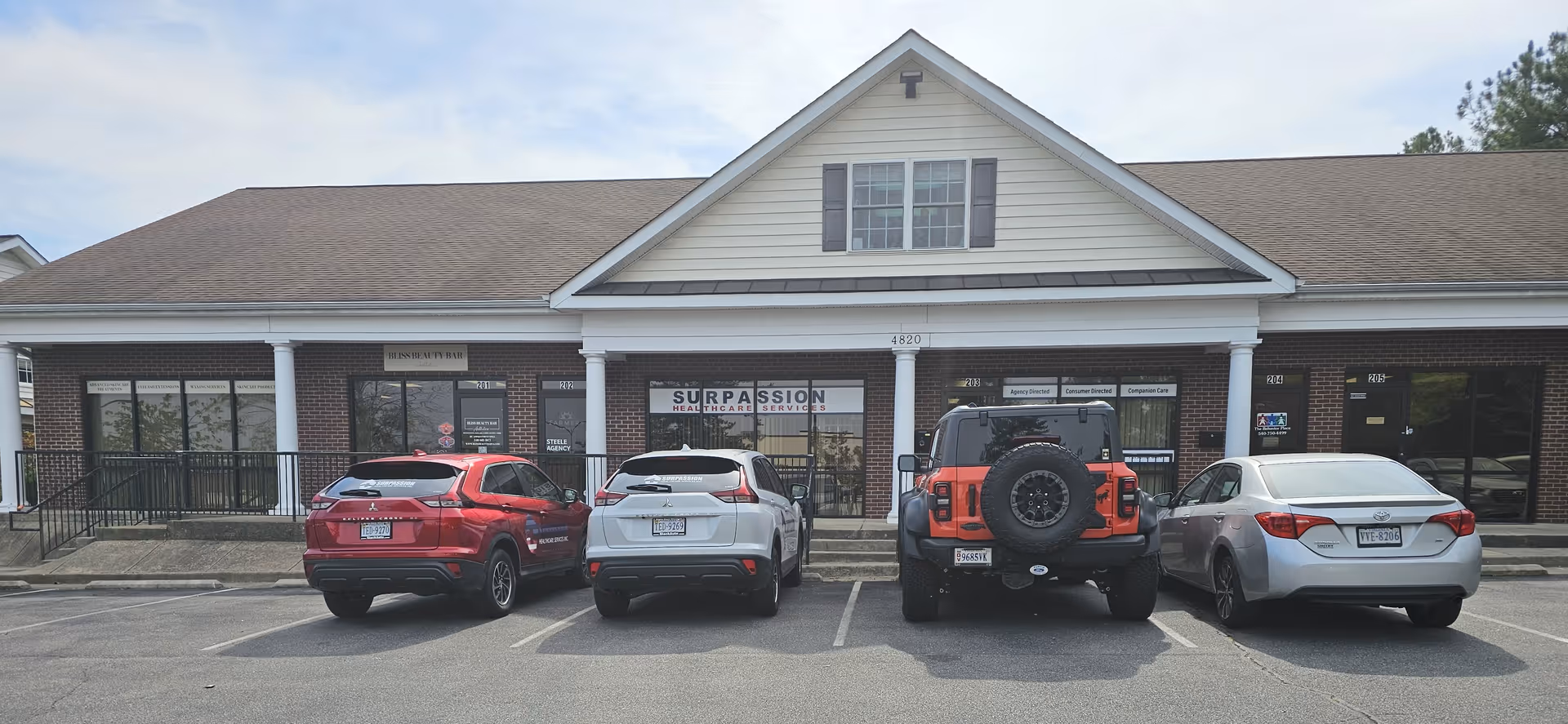 Exterior view of Surpassion Health Care Services Inc. with parked cars in front.