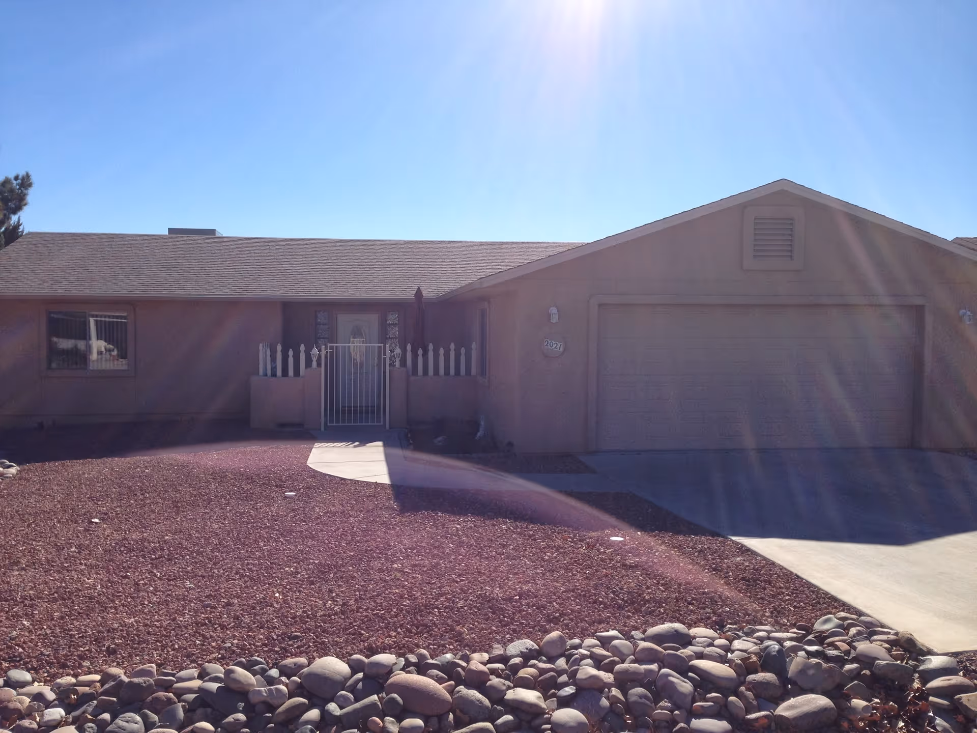 Front view of a single-story Hillsman House Independent Living home with a two-car garage.