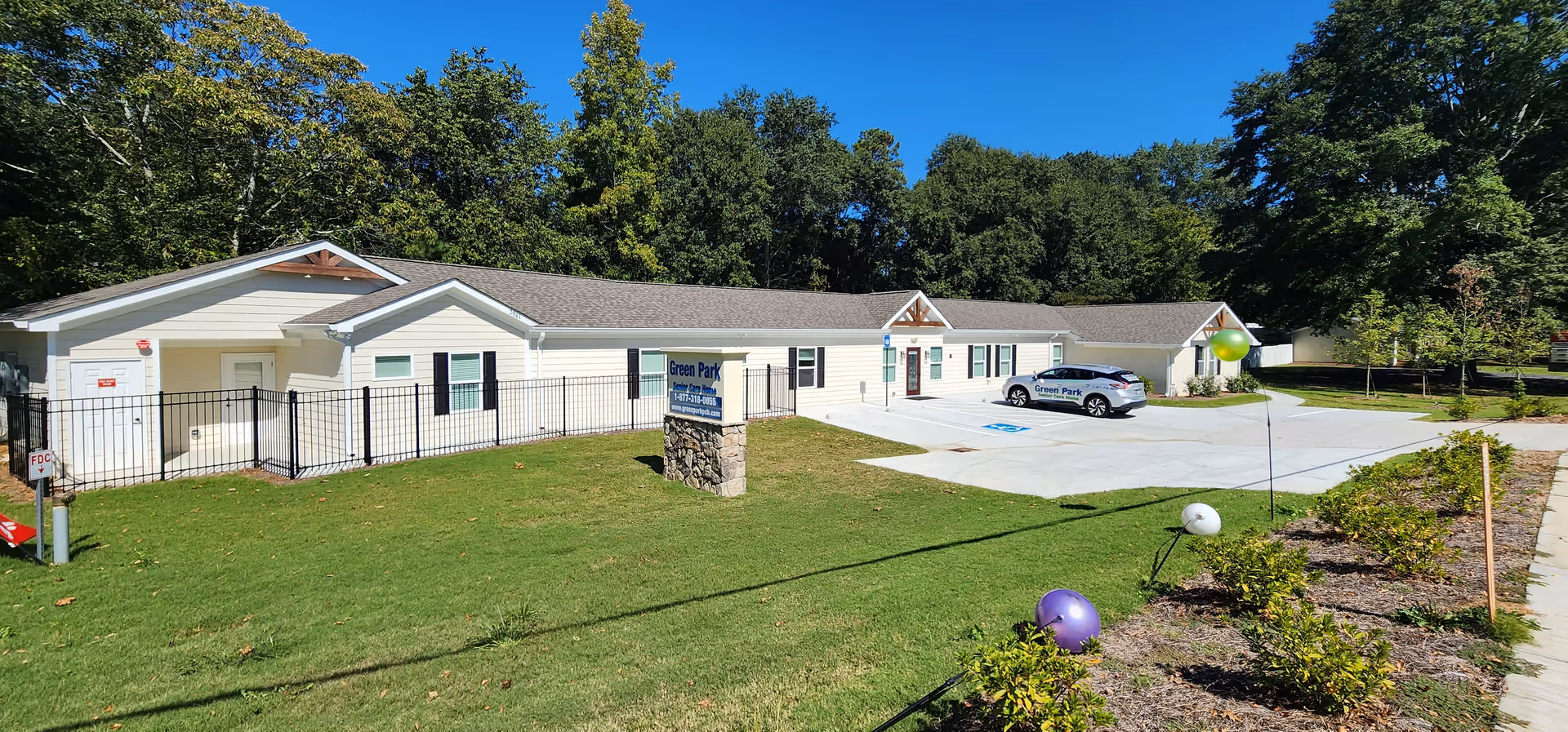 Exterior of Green Park PCH - Marietta senior living facility with parking.